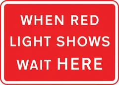 Vehicles may not pass the temporary traffic signals when the red light is shown — UK road sign