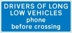 Drivers of long low vehicles must telephone to obtain permission before using a railway or tramway level crossing — UK road sign