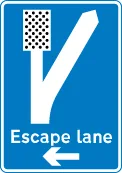 Direction to escape lane ahead for vehicles unable to stop on a steep hill — UK road sign