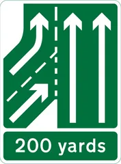 Additional traffic lane joining from the left in 200 yards. Traffic on main carriageway had priority over joining traffic from the right hand lane of the slip road (primary routes) — UK road sign